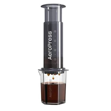 AeroPress coffee maker pressing coffee into a glass carafe